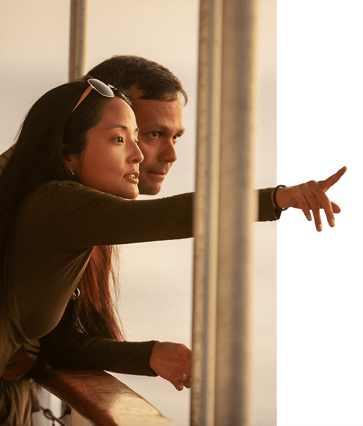 A woman pointing out to the Galapagos Islands with her significant other