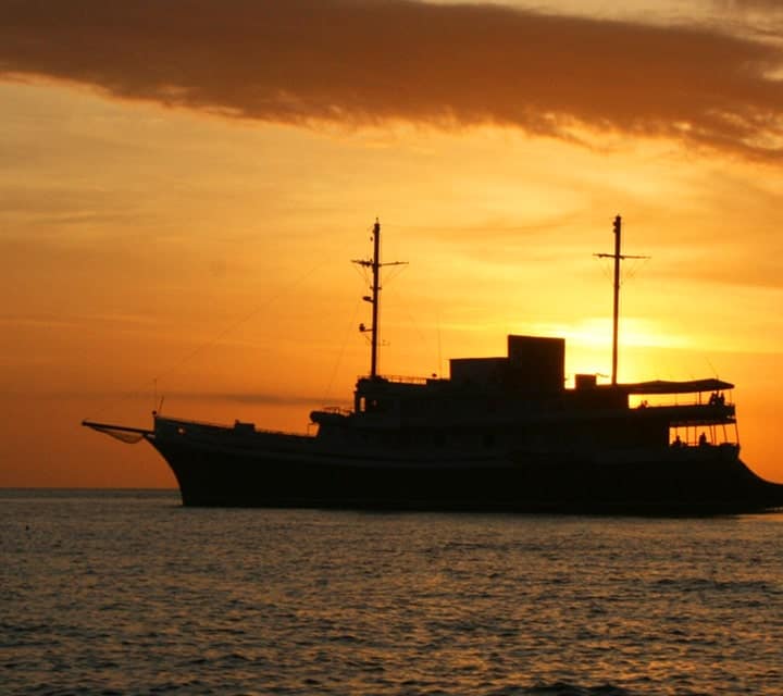 Evolution Yacht at sunset in remote Galapagos