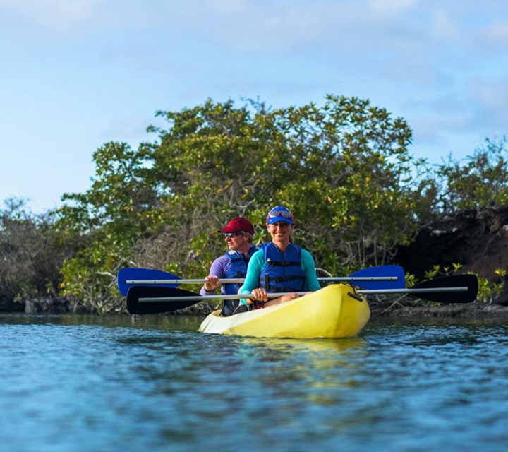 Couple kayaking Couple kayaking in the Galapagos Islands