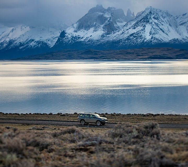All-Terrain Vehicle Adventure in Torres del Paine with Scenic Lake Reflection