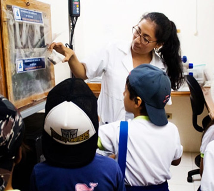 Kids learning from a presentation at the Charles Darwin Research Station about the conservation efforts of the Galapagos Islands