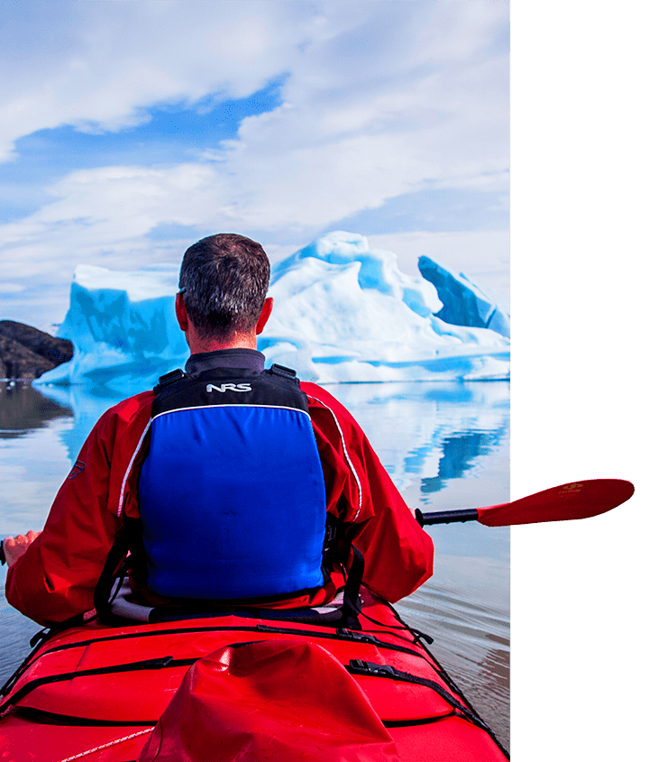 A bachelor in a red kayak paddling through the glaciers in Patagonia