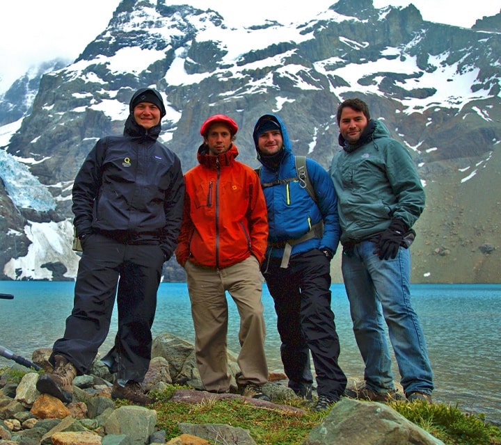 A group of men on a bachelor destination trip in Patagonia posing for a photo at the Blue Lagoon in Los Glaciares National Park, Argentina