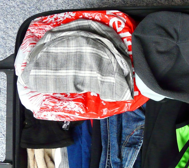 A suitcase full of clothing items and other essentials for a Galapagos cruise