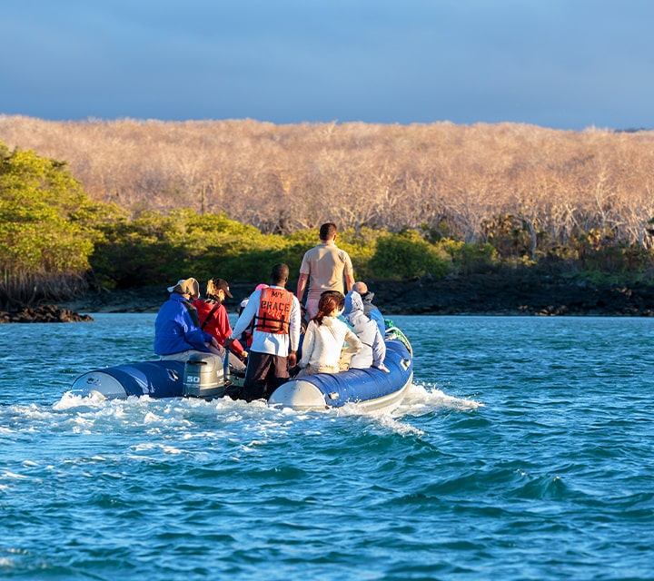 Travelers on a panga ride for a wet landing on a Galapagos Island coast