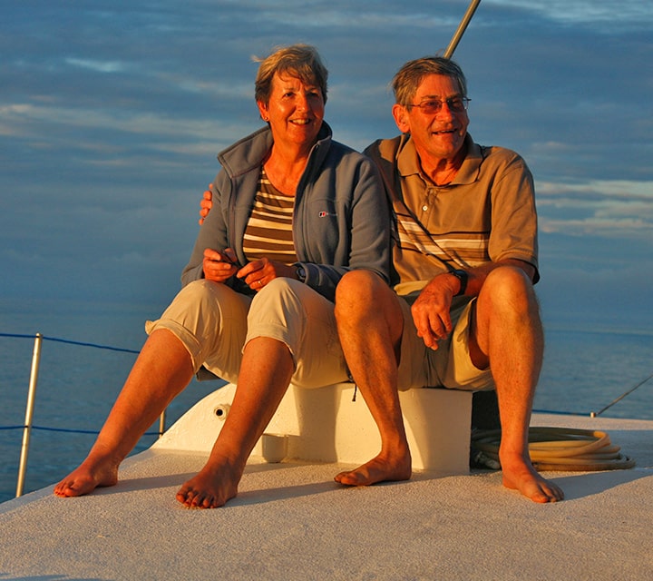 A couple sitting towards the sunset on a Galapagos boat