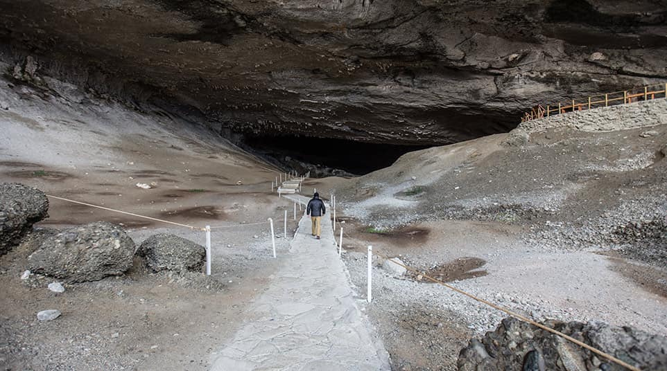 Traveler walking into the Mylodon Cave Traveler walking into the Mylodon Cave