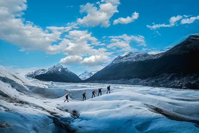 Small group of travelers ice trekking in Patagonia