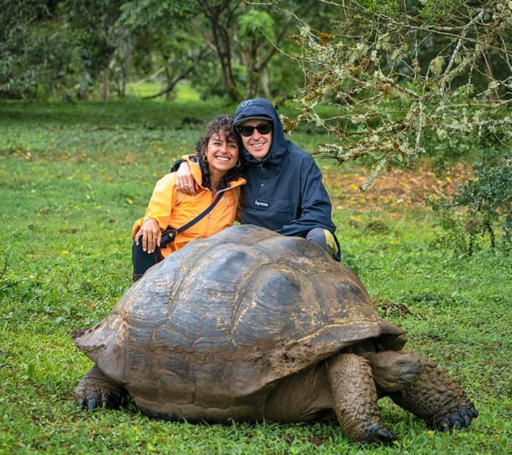 taking a picture with galapagos tortoise in the wetlands