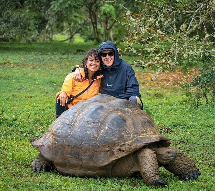 taking a picture with galapagos tortoise in the wetlands taking a picture with galapagos tortoise in the wetlands