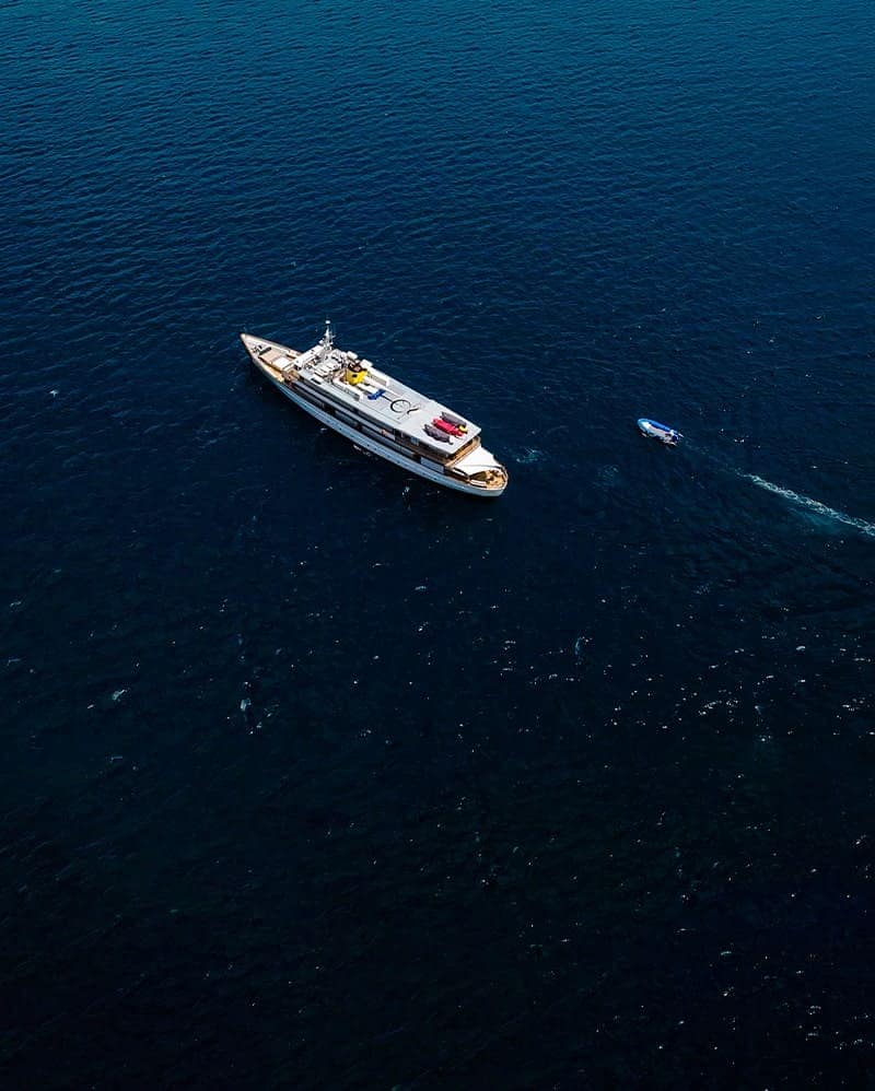 Aerial view of Grace Yacht sailing through the pristine ocean waters of the Galapagos Islands