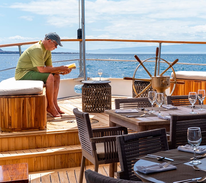 Reading a book on the Galapagos Grace Yacht