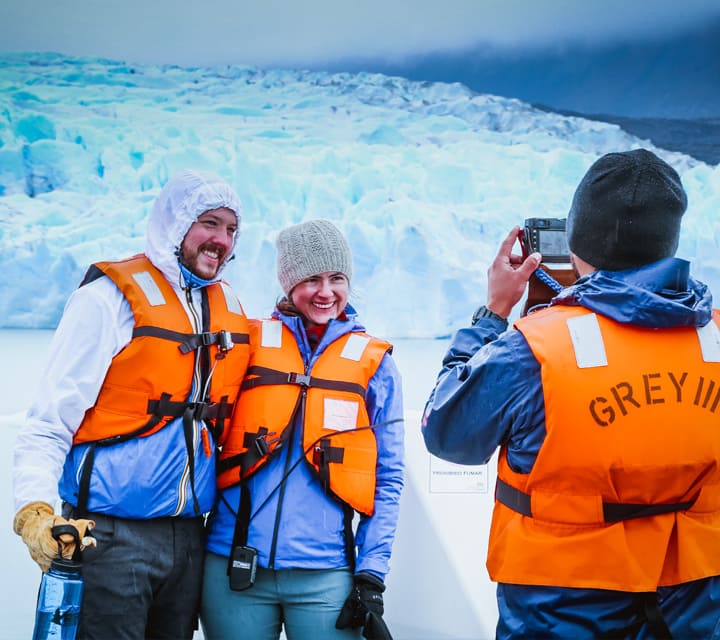 Couple taking pictures at Perito Moreno Glacier