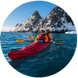 Kayak by Icebergs in Antarctica