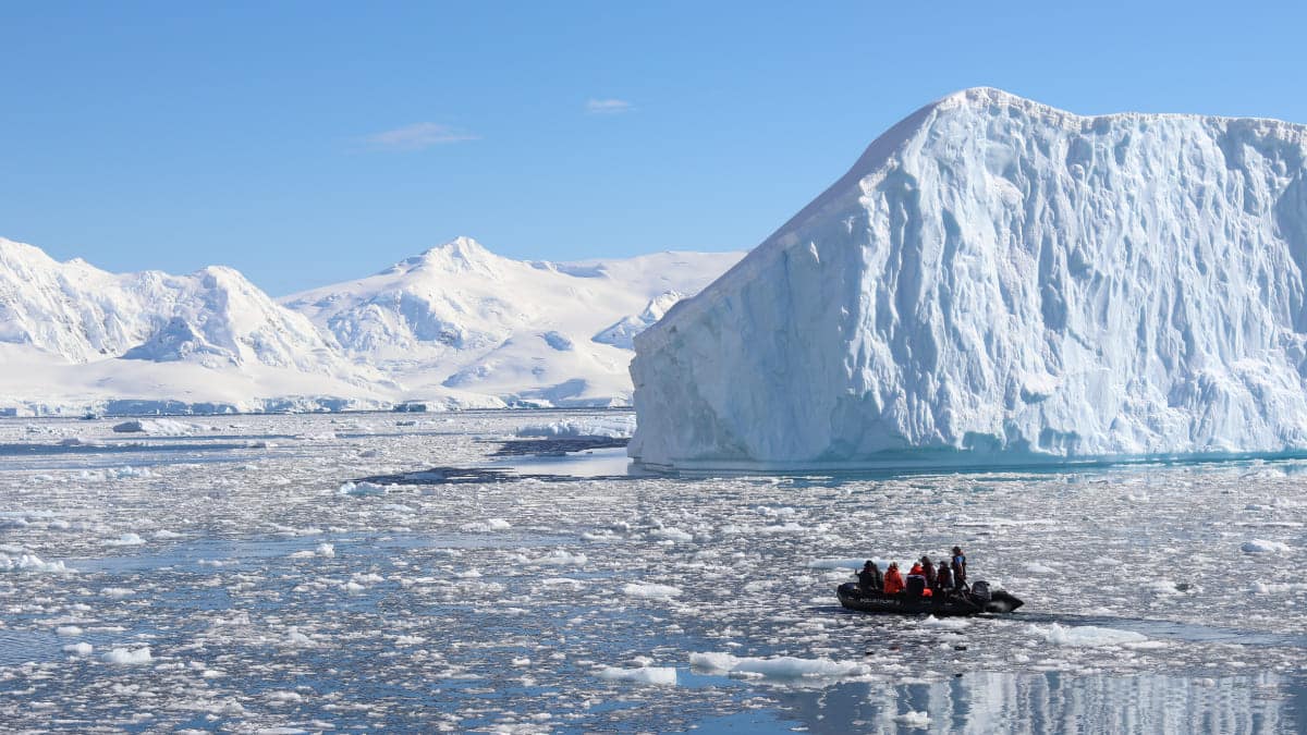 Antarctica cruise zodiac next to iceberg Antarctica cruise zodiac next to iceberg