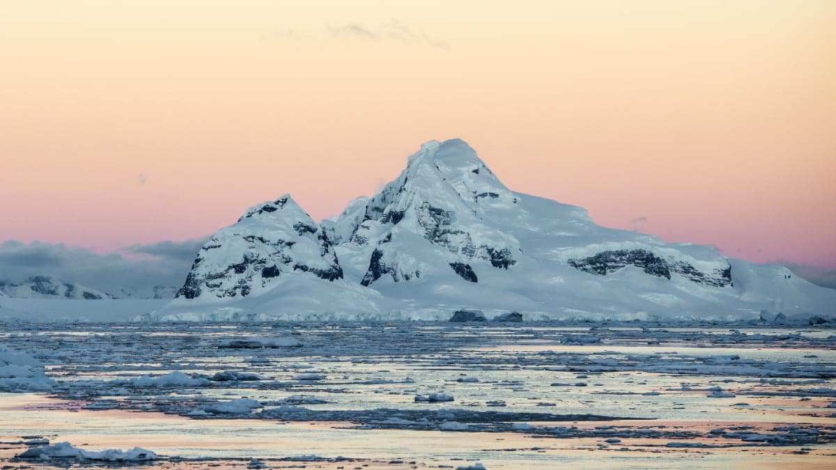 Snowy peak sunset in Antarctica Snowy peak sunset in Antarctica